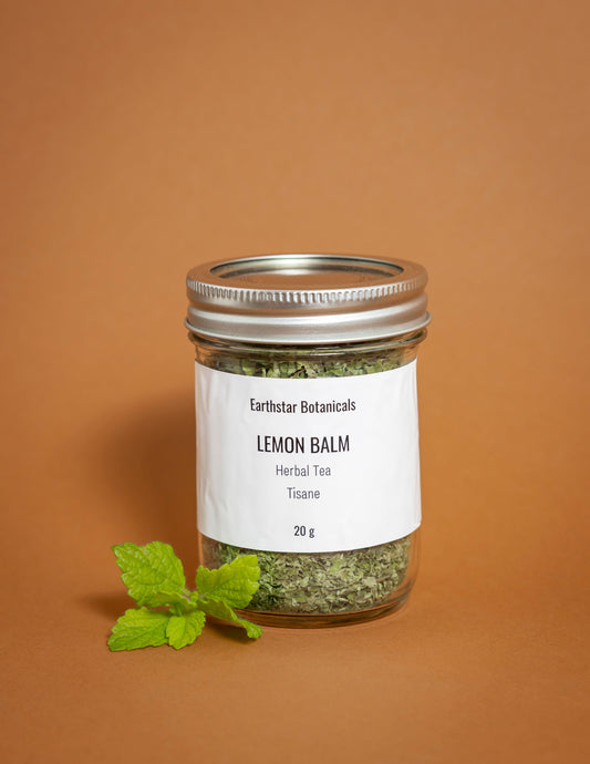 Jar of Lemon Balm herbal tea with a label on an orange background