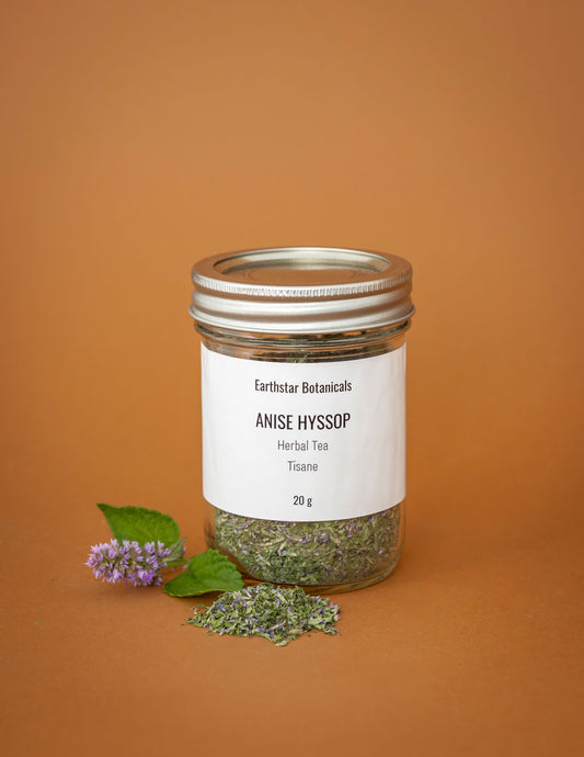 Jar of Earthstar Botanicals Anise Hyssop herbal tea on an orange background